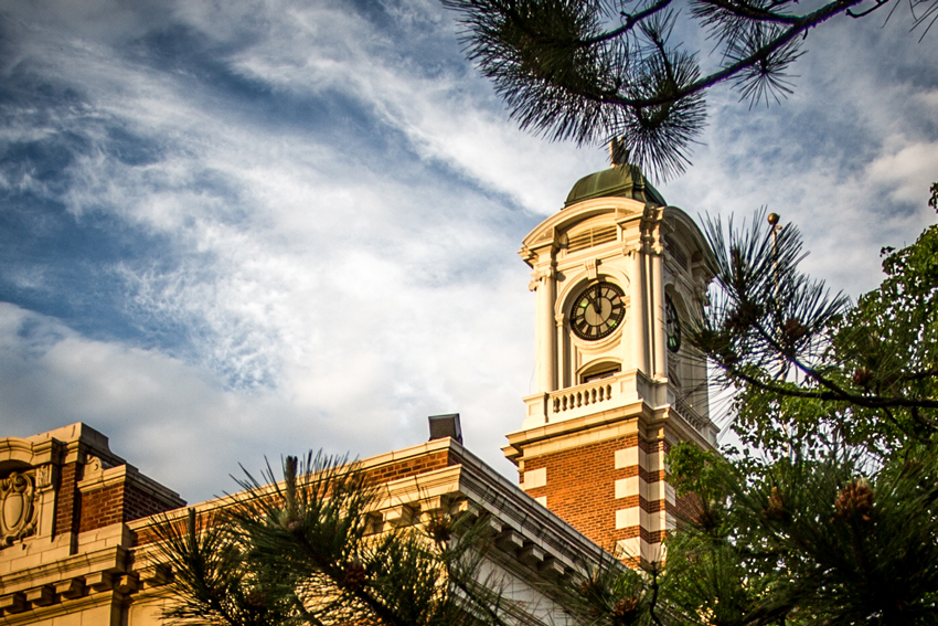 Clock tower with cloudy blue sky in the background