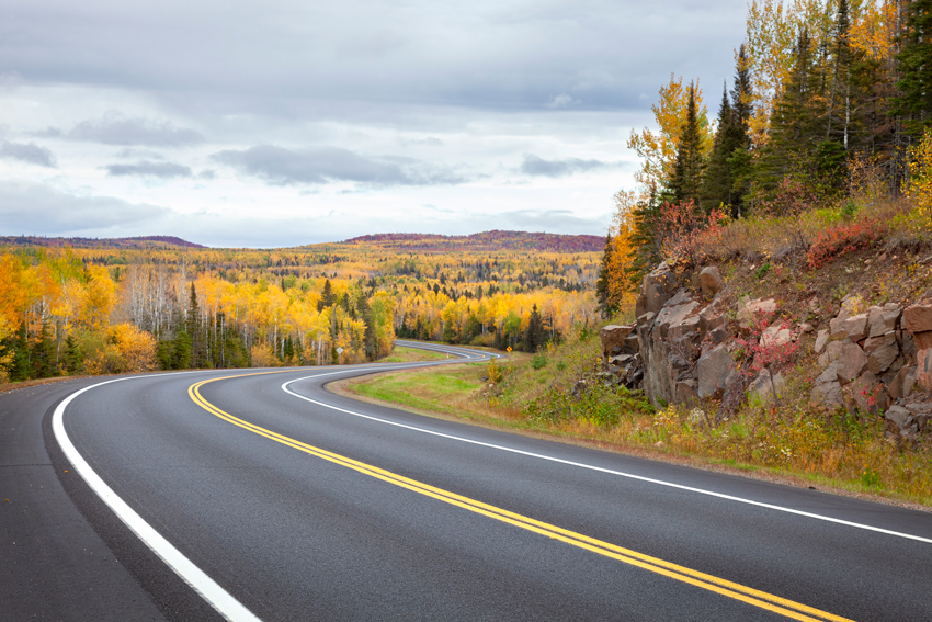 Empty highway winding through scenic hills
