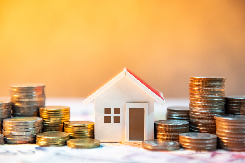 A toy house with stacks of coins on either side