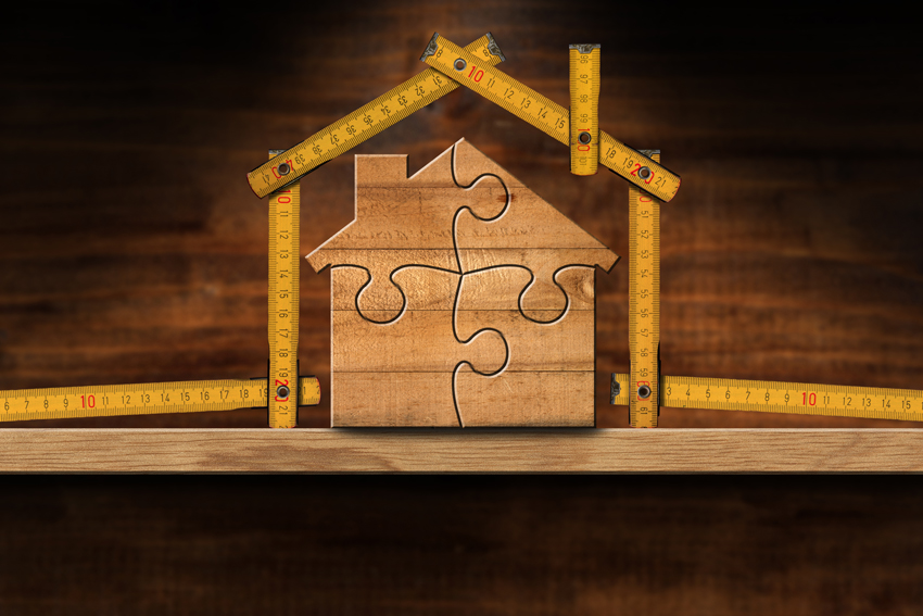 Graphic of a house made of wooden puzzle pieces