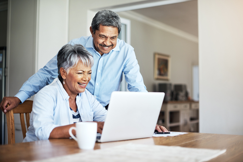 Senior couple looking at a laptop together